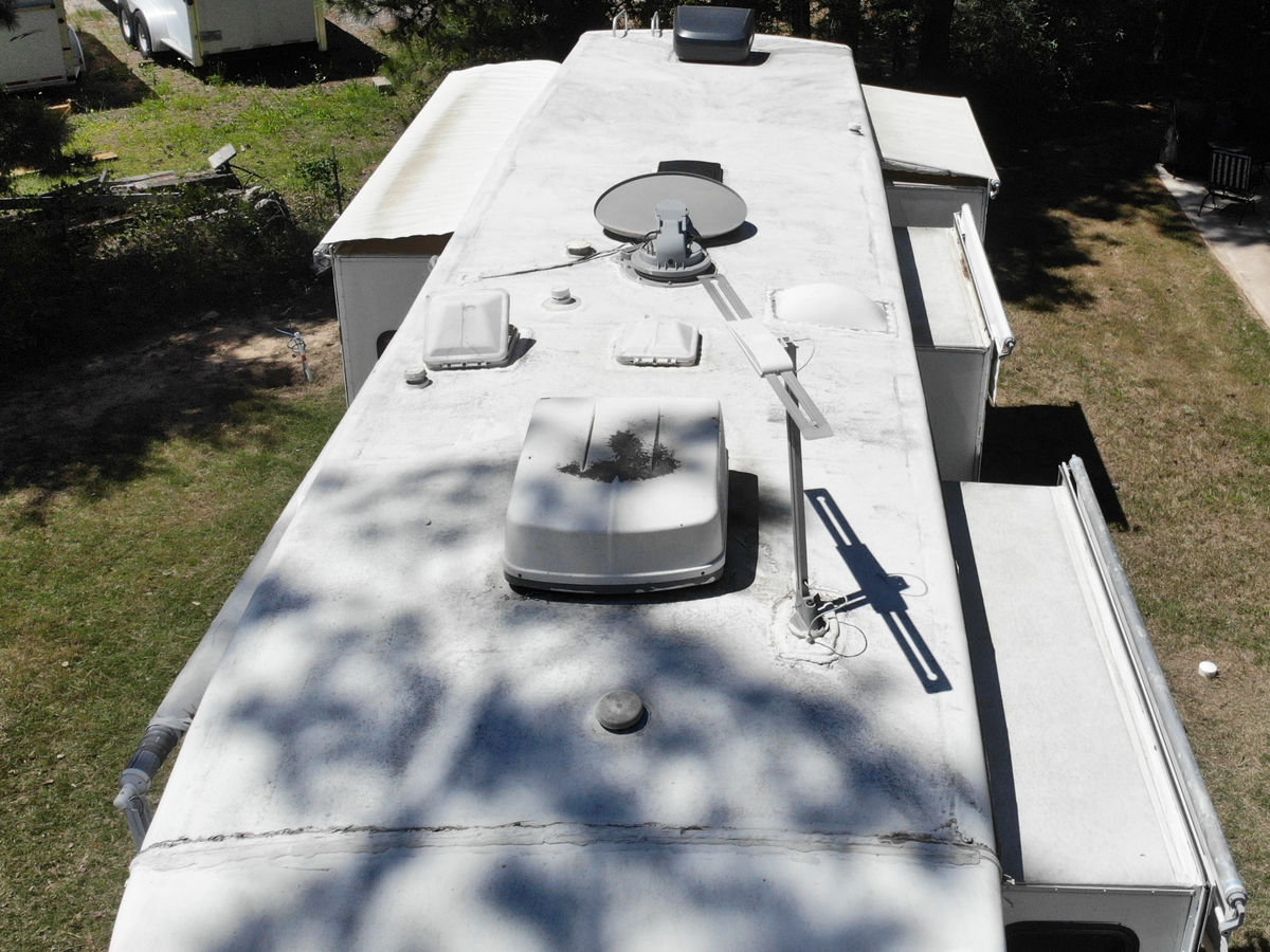 Aerial view of an RV roof being cleaned and maintained