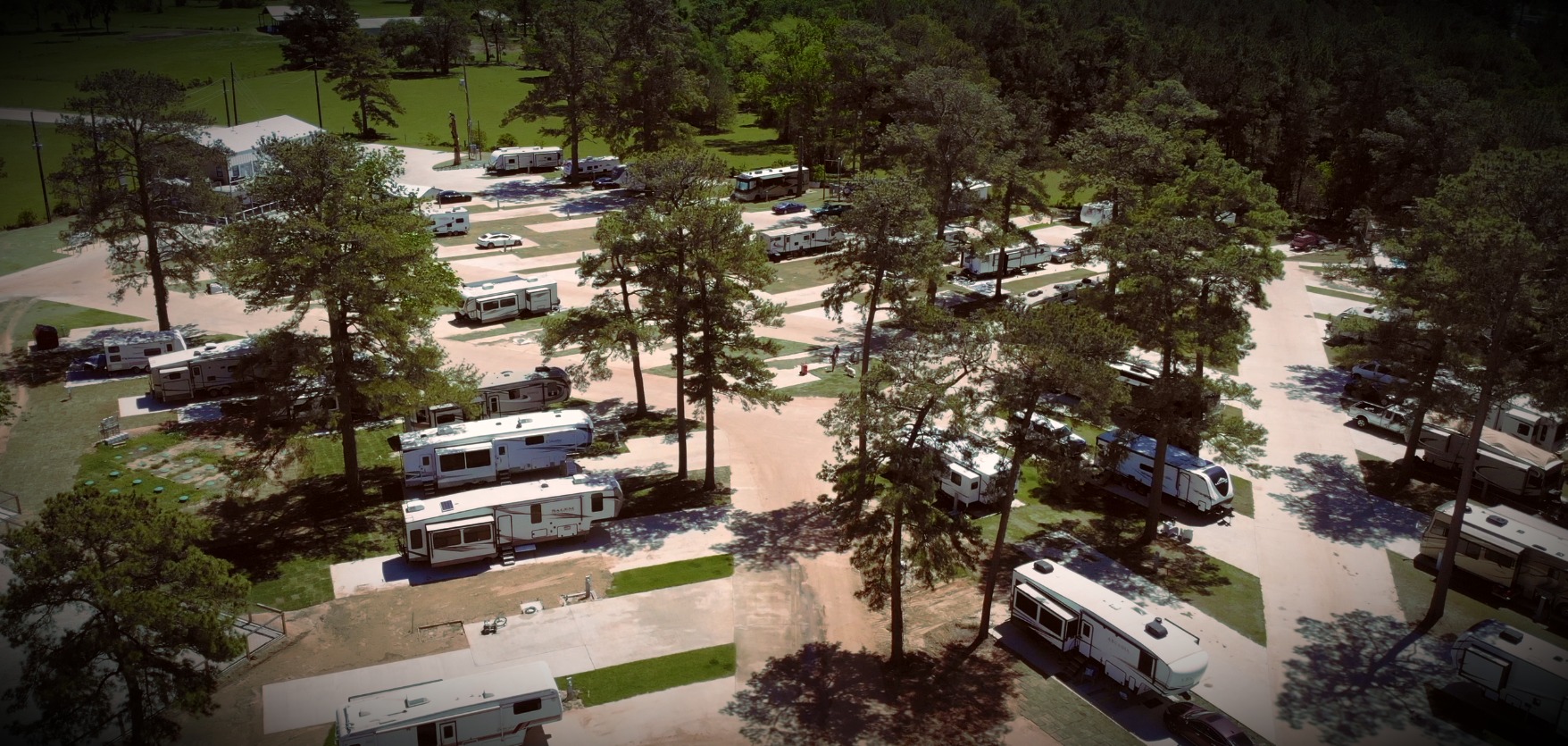 Aerial image showing the resort and all of the large sites and pine trees providing plenty of shade.