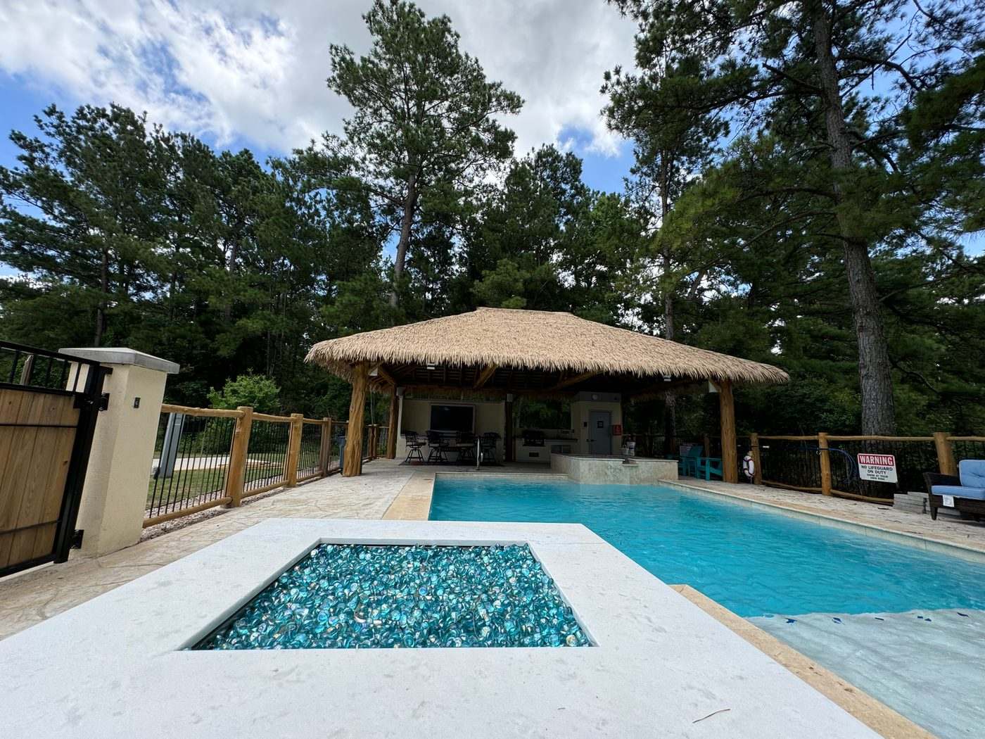 Resort pool with the tiki palapa and lounge seating