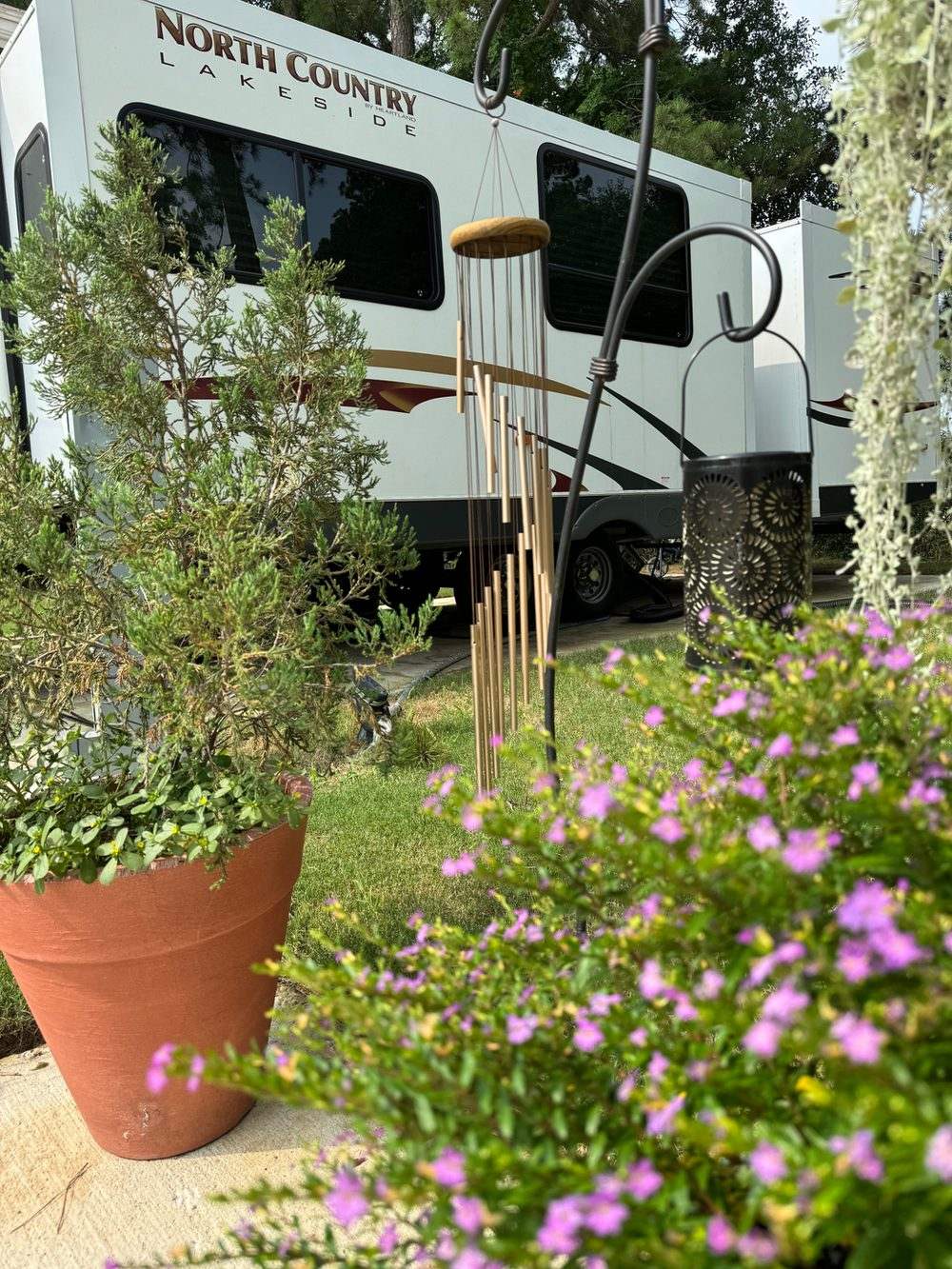RV site with potted flowers at Hidden Lake RV Resort