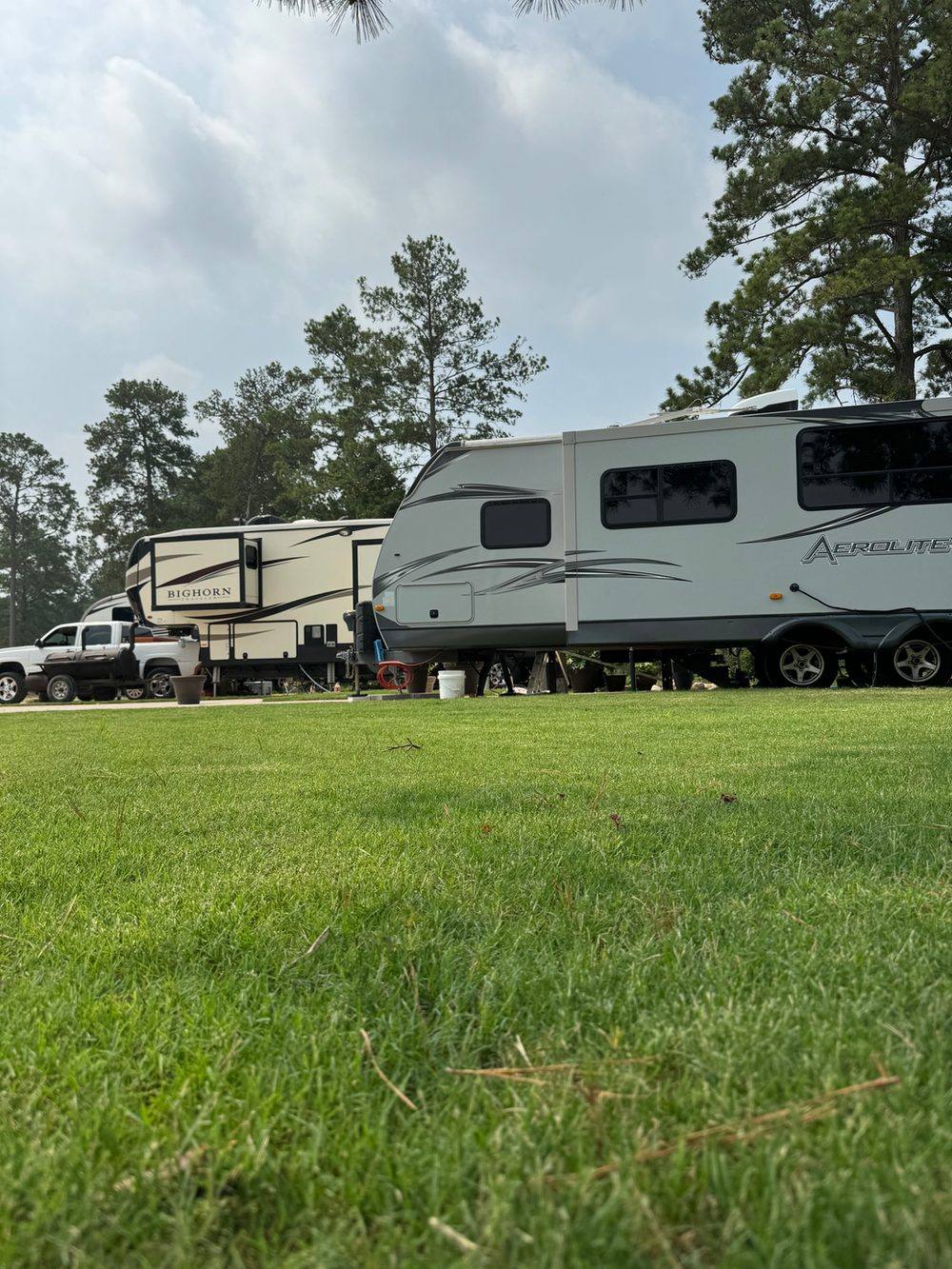 RV parked on a shaded site at Hidden Lake RV Resort