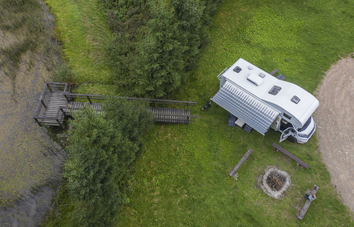 Image of an RV Campsite set up on a lake with a dock